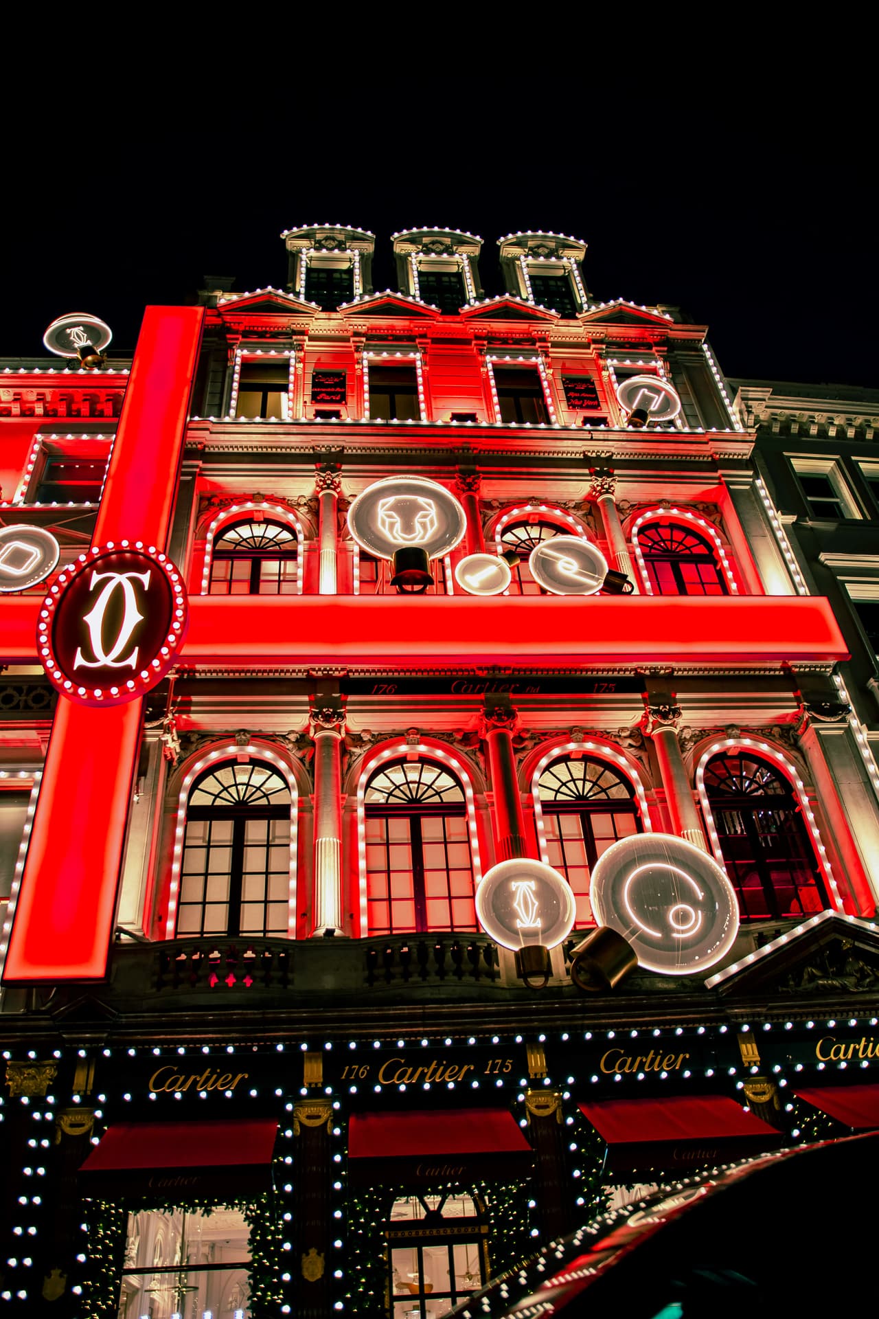 A Bond Street storefront lit red for Christmas
